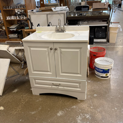 White vanity with top and faucet